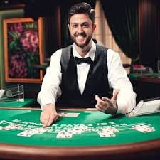 Roulette wheel spinning in live dealer studio with player chat visible